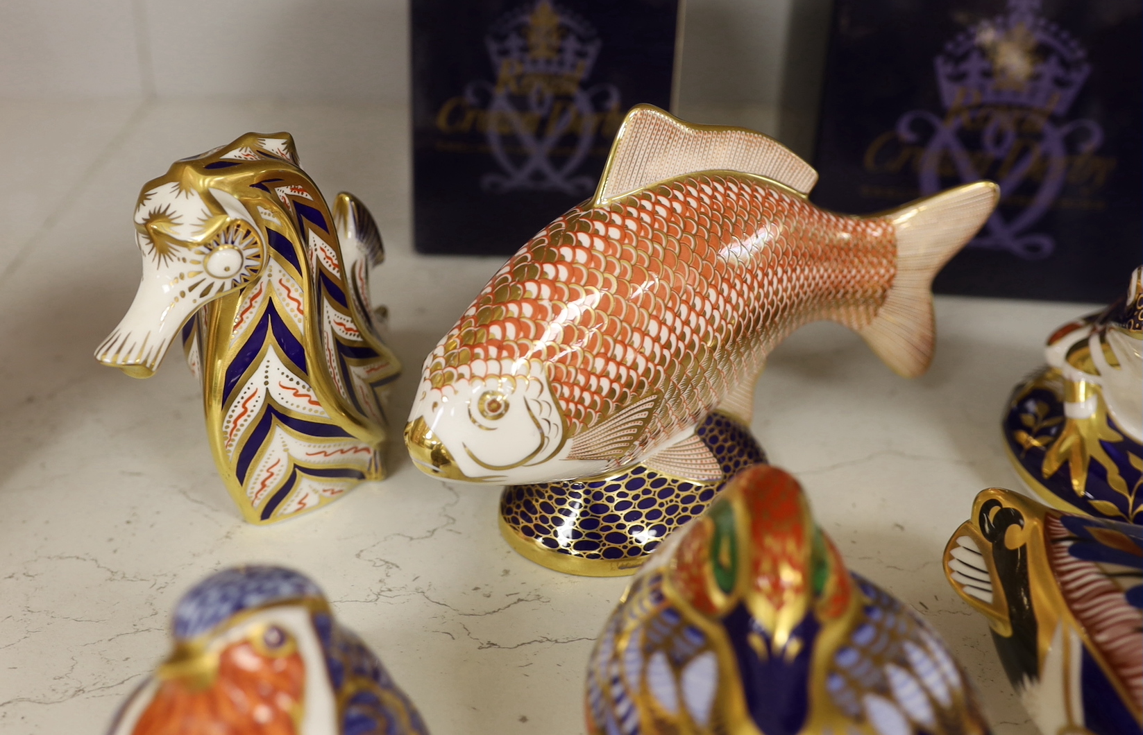 A collection of nine Royal Crown Derby paperweights